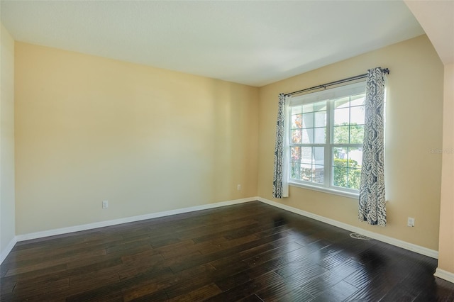 unfurnished room with dark hardwood / wood-style floors