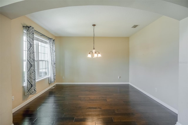 unfurnished dining area with dark hardwood / wood-style floors and a chandelier