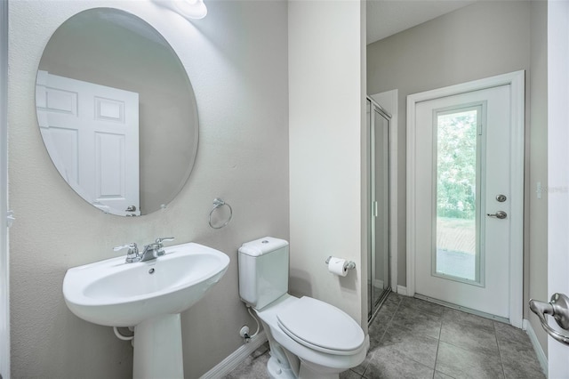 bathroom featuring toilet and a shower with door