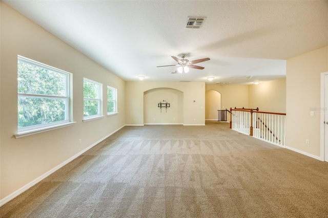 unfurnished room featuring ceiling fan and light carpet