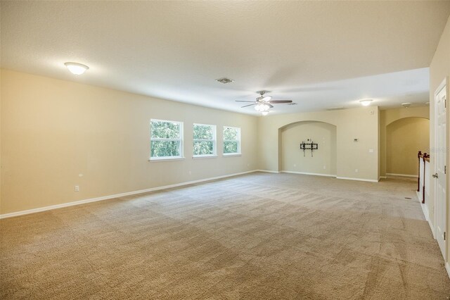 spare room with ceiling fan and light colored carpet