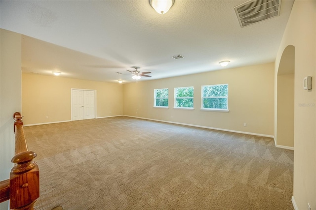 unfurnished room with ceiling fan and carpet floors