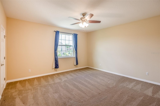 empty room featuring carpet floors and ceiling fan