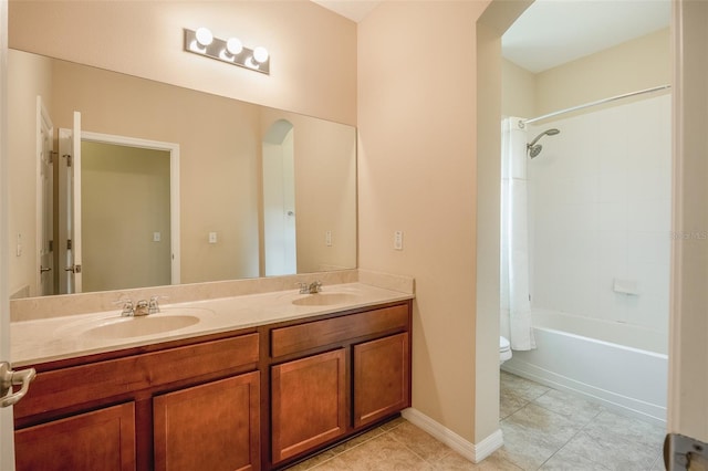 full bathroom featuring toilet, vanity, and tiled shower / bath