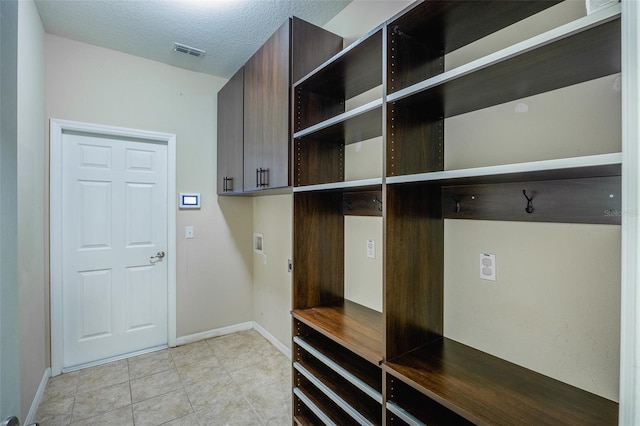 mudroom featuring a textured ceiling