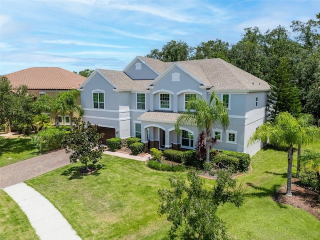 view of front of home with a garage and a front lawn