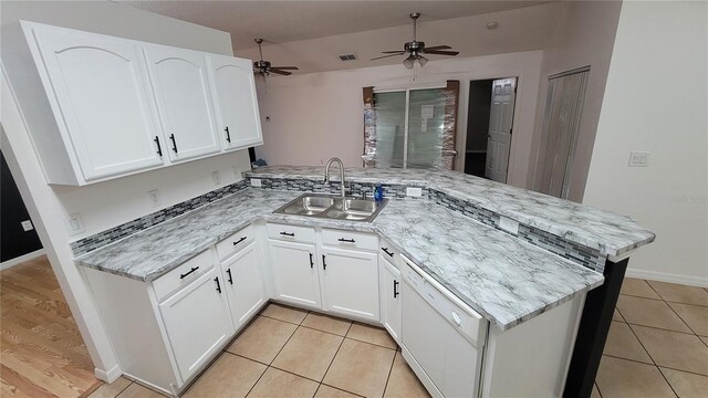 kitchen featuring sink, light tile patterned floors, dishwasher, ceiling fan, and kitchen peninsula