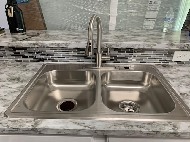 room details featuring a sink and backsplash