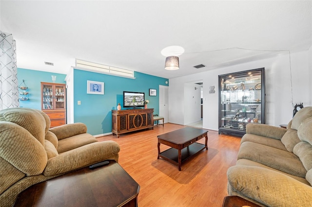 living room featuring a healthy amount of sunlight and hardwood / wood-style flooring