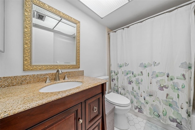 bathroom with toilet, vanity, a shower with curtain, and tile patterned floors