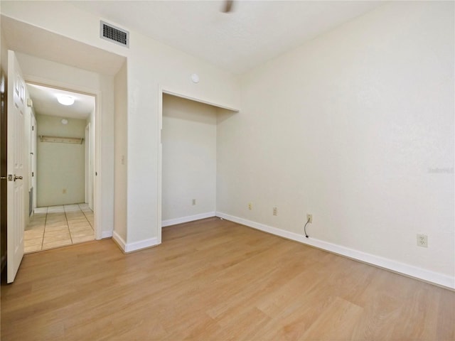 unfurnished room with light wood-type flooring