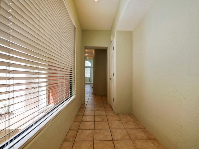 corridor featuring light tile patterned floors