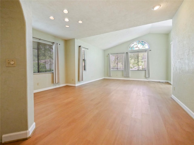 unfurnished living room with light hardwood / wood-style flooring and vaulted ceiling