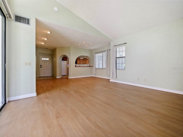 unfurnished living room with light hardwood / wood-style flooring and lofted ceiling