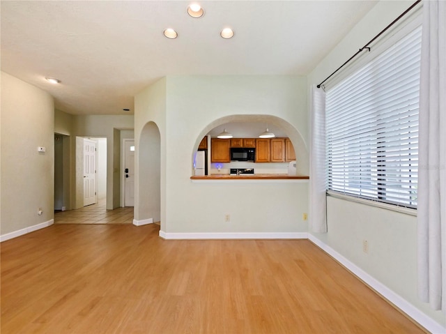 unfurnished living room with light tile patterned floors