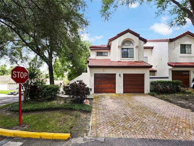 mediterranean / spanish house with a garage