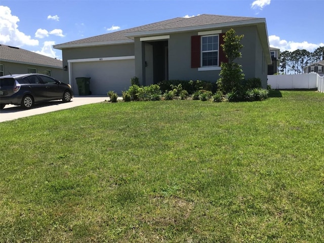 single story home with a garage and a front lawn