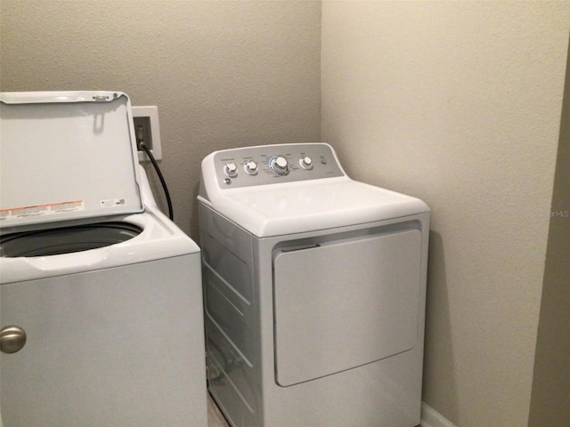 washroom with washer and dryer