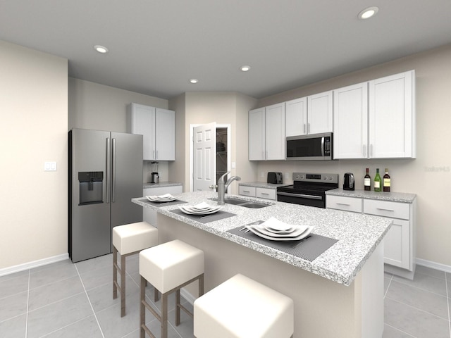 kitchen with sink, a kitchen island with sink, light tile patterned floors, and stainless steel appliances