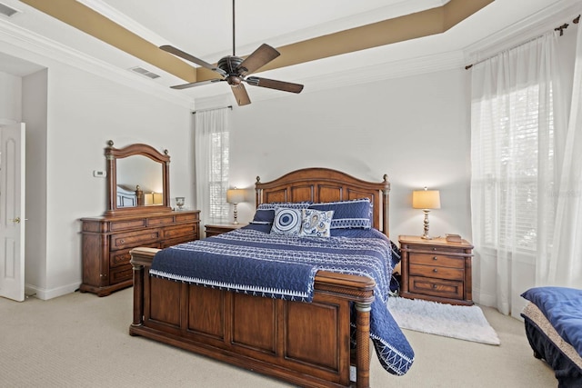 carpeted bedroom with ceiling fan, ornamental molding, and multiple windows