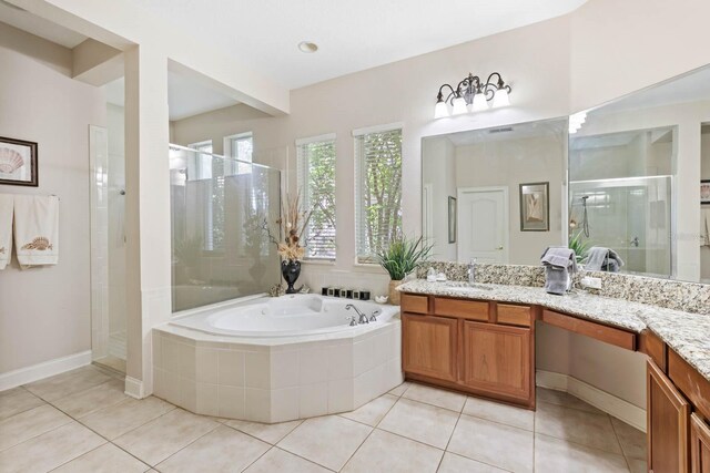 bathroom with independent shower and bath, tile patterned flooring, and vanity