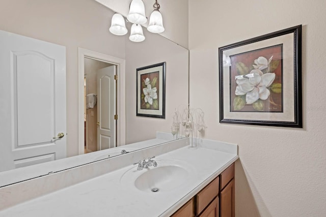 bathroom featuring an inviting chandelier and vanity