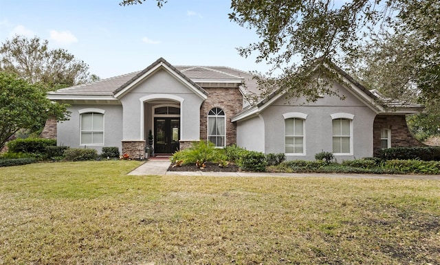 view of front of property with french doors and a front lawn