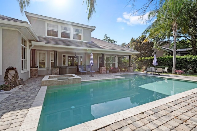 view of pool featuring a patio area and a hot tub