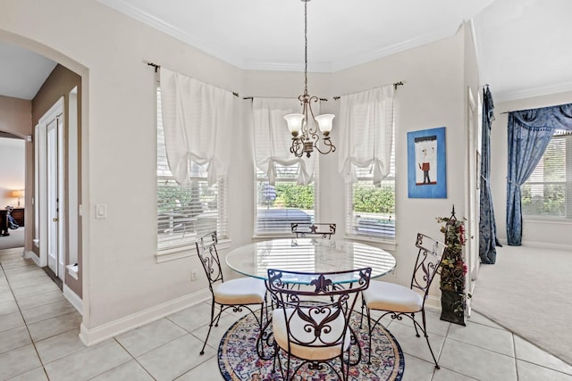 tiled dining room featuring an inviting chandelier and ornamental molding