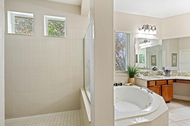 bathroom featuring tile patterned flooring, plus walk in shower, and vanity