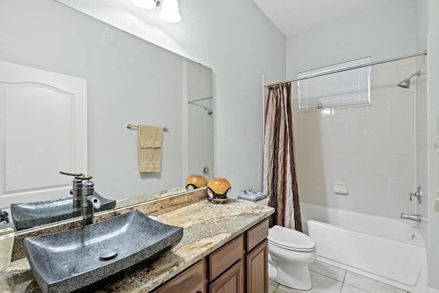 full bathroom featuring tile patterned flooring, vanity, toilet, and shower / bath combo