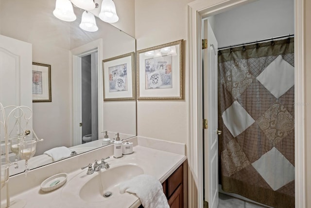 bathroom with a shower with shower curtain, vanity, and toilet