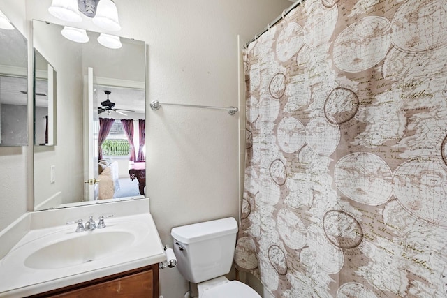 bathroom featuring vanity, ceiling fan, toilet, and walk in shower