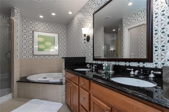 bathroom with vanity, tile patterned floors, independent shower and bath, and tile walls