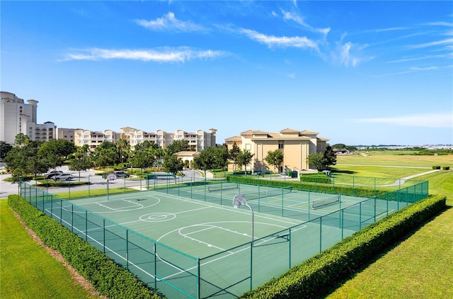 exterior space with a yard and tennis court