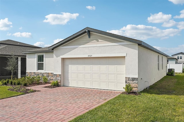 view of front of property featuring stone siding, stucco siding, decorative driveway, and a front lawn