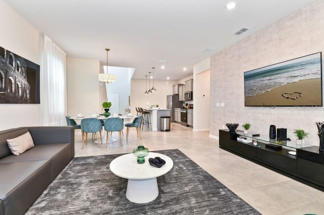 tiled living room with a chandelier