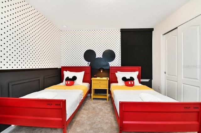 bedroom featuring light carpet and a closet