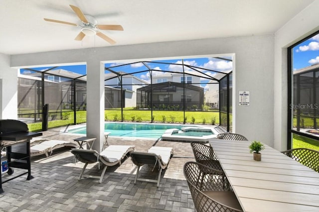 sunroom featuring ceiling fan