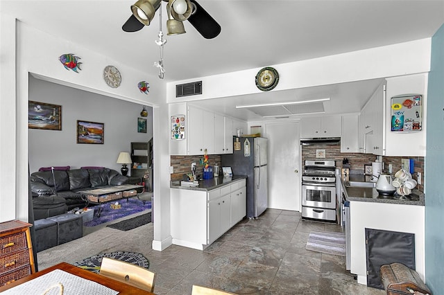 kitchen with stainless steel appliances, tasteful backsplash, and white cabinets