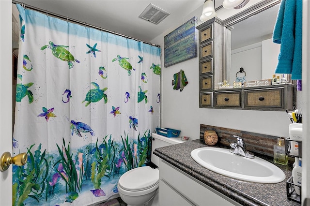 bathroom featuring vanity, toilet, and a shower with shower curtain