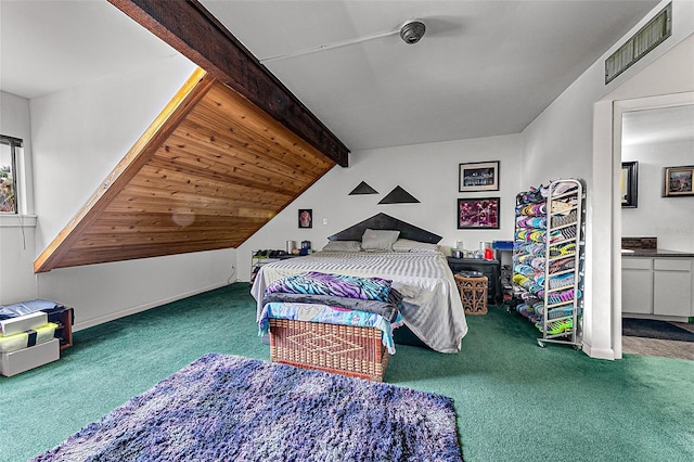 carpeted bedroom featuring ensuite bathroom and lofted ceiling with beams