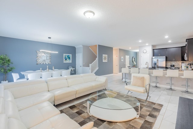 tiled living room with an inviting chandelier and sink