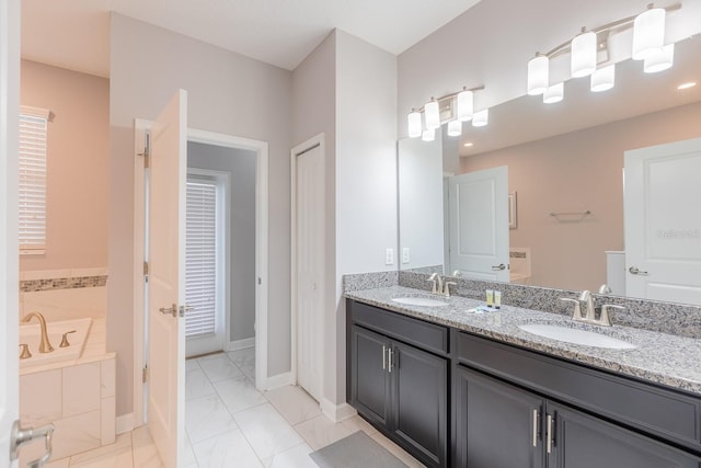 bathroom featuring dual vanity, a relaxing tiled tub, and tile patterned floors