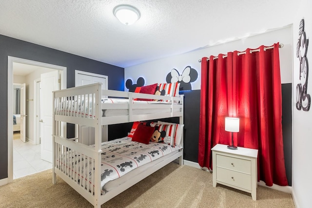 bedroom with a textured ceiling and carpet flooring