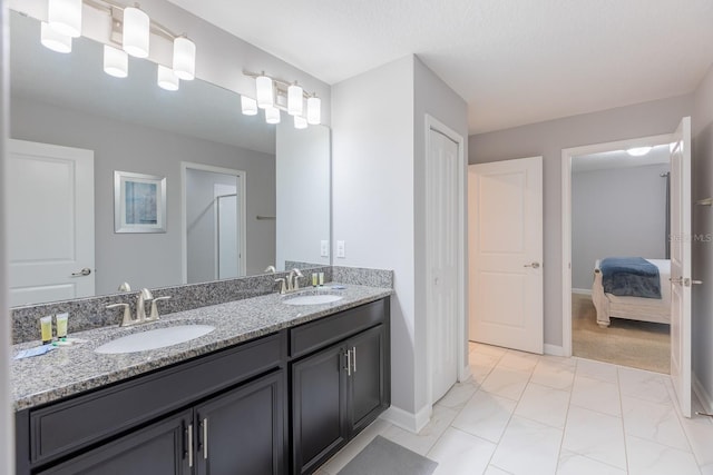 bathroom with dual vanity and tile patterned flooring