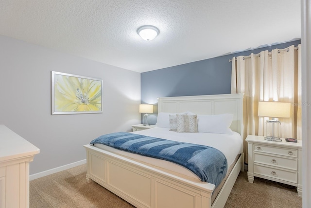 bedroom featuring carpet floors and a textured ceiling