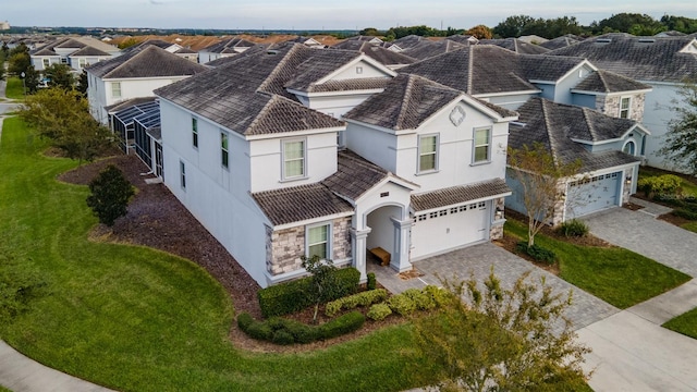 view of front of home with a garage and a front lawn