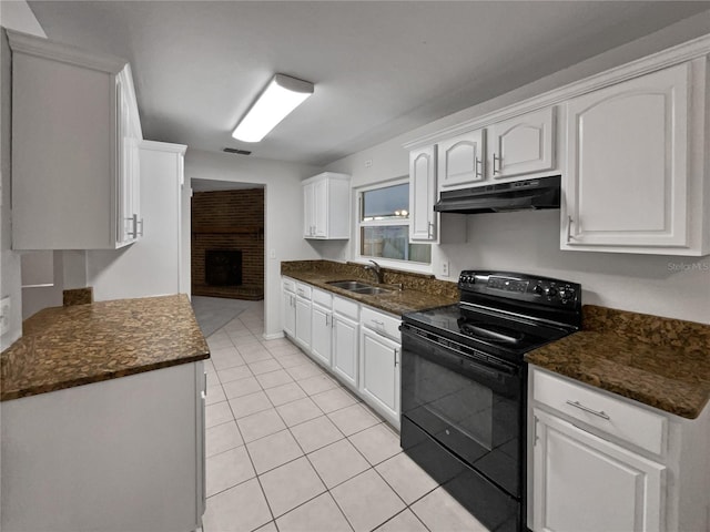 kitchen with white cabinetry, sink, light tile patterned floors, and black electric range