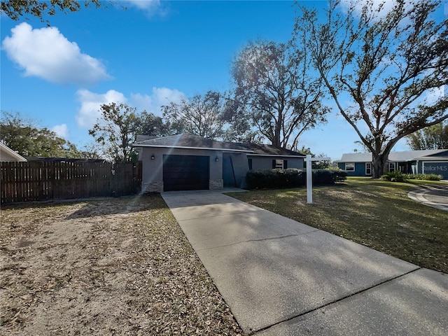 view of front of house with a front yard and a garage